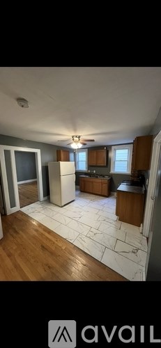 A living room with a white ceiling and wooden floors.