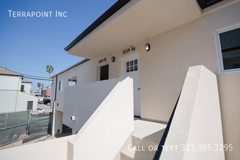 A building with the text "TERRAPOINT INC" on the top left corner and a phone number "323.985.3295" on the bottom right corner.