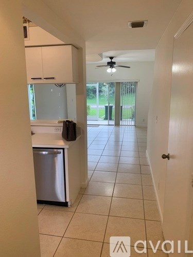 A kitchen with white cabinets and a stainless steel dishwasher.