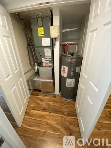 A room with a heater and a water tank.