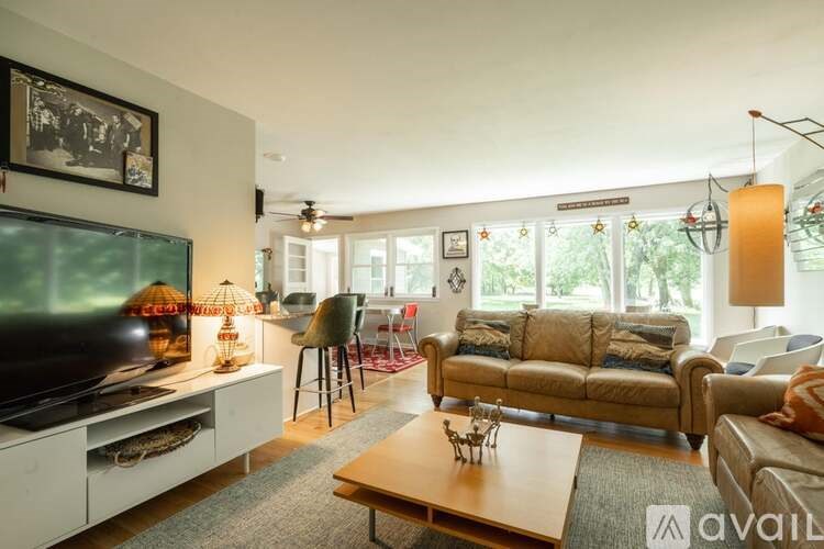 A living room with a television, couches, and a coffee table.