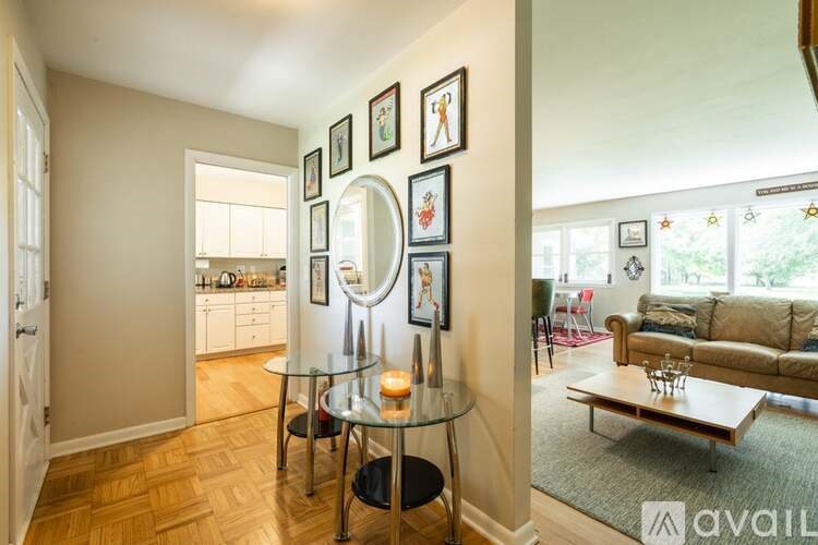 A living room with a glass table and a couch.