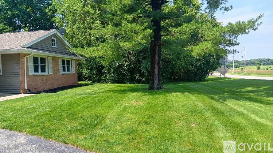A house with a tree in front of it.