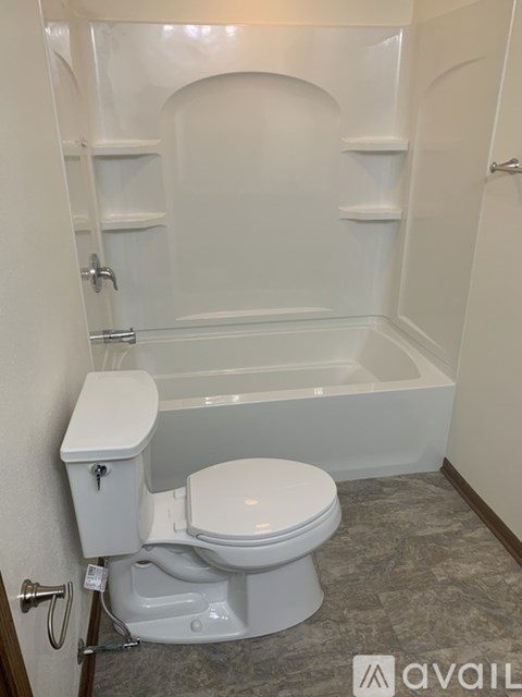A white toilet in a bathroom with a bathtub.