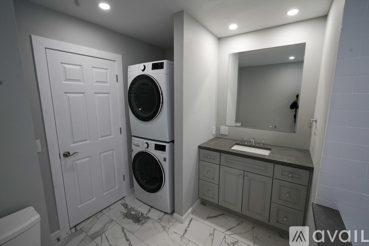 A bathroom with a washer and dryer in it.