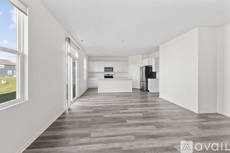 A spacious kitchen with white cabinets and a large island.