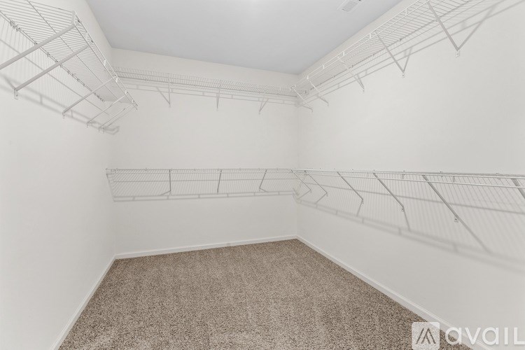 Empty room with white walls and a carpeted floor.