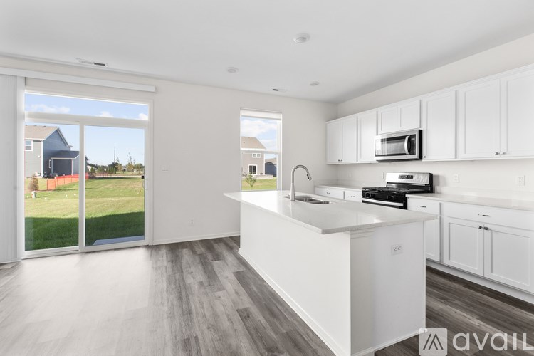 A modern kitchen with white cabinets and a large island.