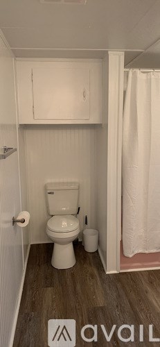 A small white toilet in a small bathroom.