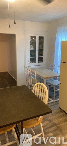 A kitchen with a table and chairs.