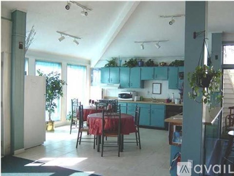 A kitchen with a table and chairs in the middle of the room.