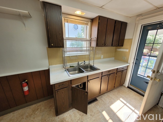 A kitchen with wooden cabinets and a white countertop.