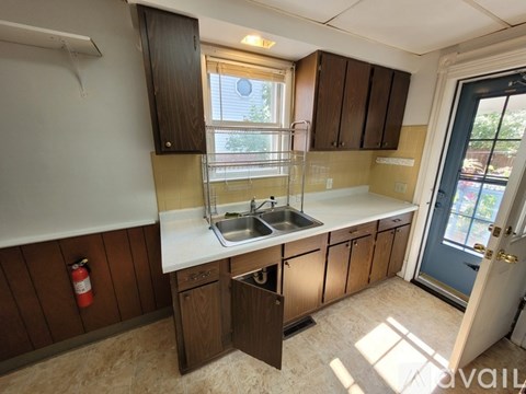 A kitchen with wooden cabinets and a white countertop.
