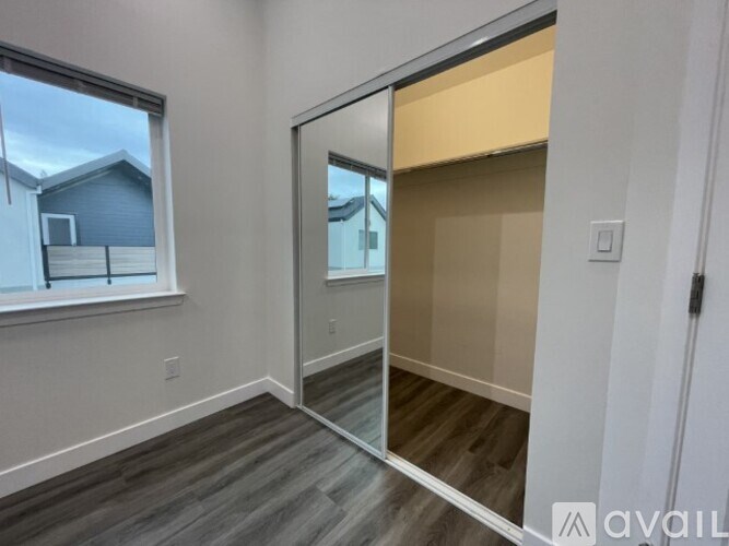 A room with a sliding glass door leading to a balcony.