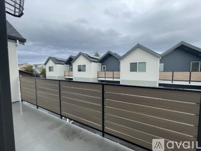 A row of houses with a fence in front.