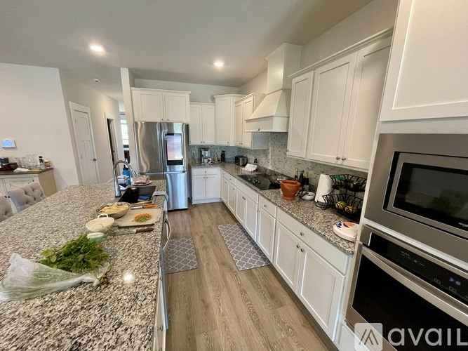 A kitchen with granite countertops and stainless steel appliances.