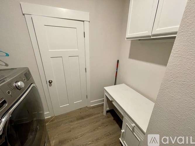 A small laundry room with a washer and dryer.