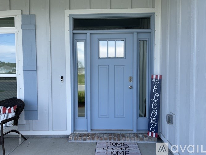A blue door with a glass window and a sign that says Home Sweet Home.