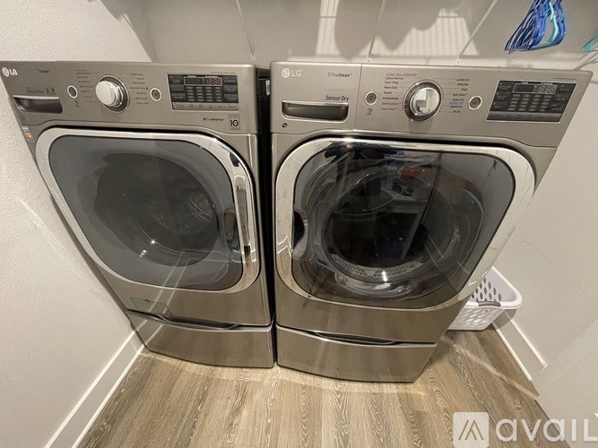 Two front loading washing machines are side by side.