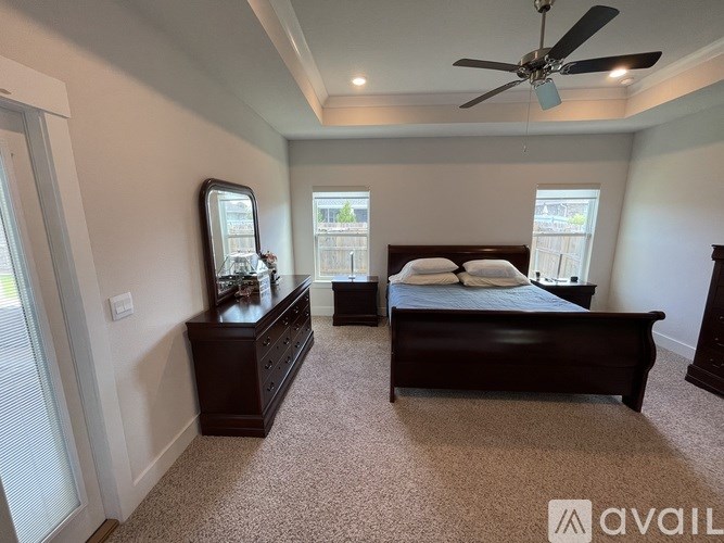 A bedroom with a bed, dresser, and mirror.
