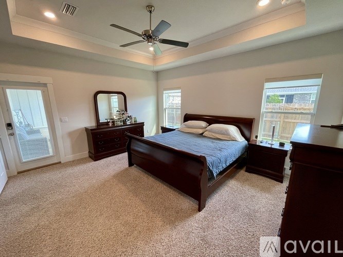 A bedroom with a bed, dresser, and mirror.