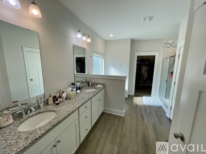 A bathroom with two sinks and a large mirror.
