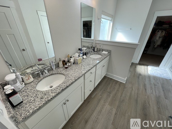 A bathroom with a granite countertop and a large mirror.