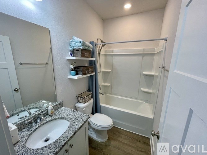 A bathroom with a sink, toilet, and bathtub.