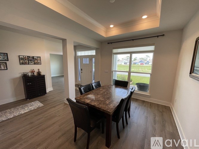 A dining room with a table and chairs is available for rent.