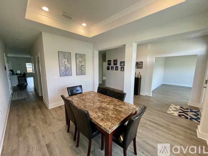 A dining room with a table and chairs.