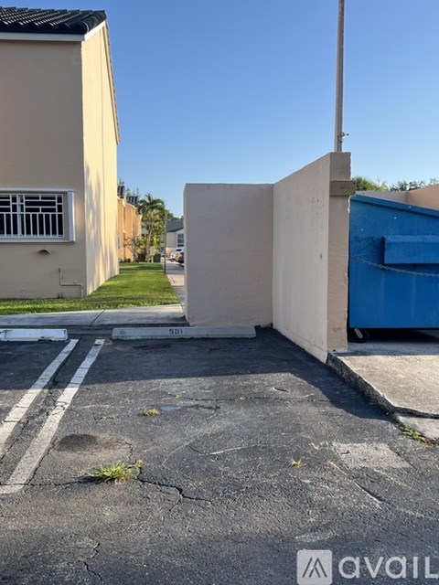 A parking lot with a white line and a building in the background.