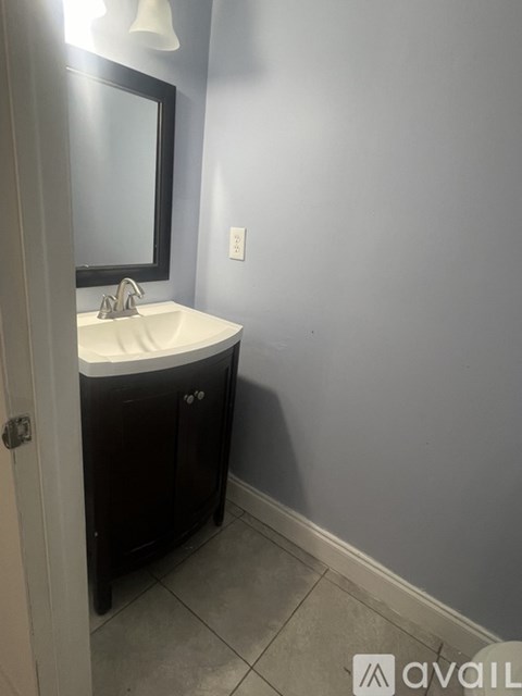A bathroom with a sink and a mirror.