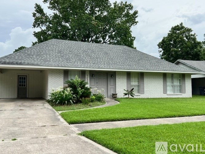 A house with a grey roof and white walls is shown.