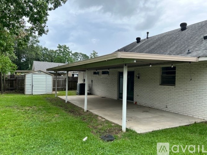 A house with a covered porch and a fence in the background.