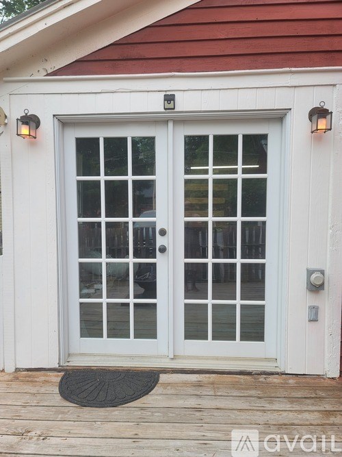 A white double door with a glass panel and sidelights.