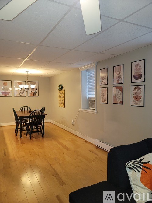 A living room with a dining table and chairs.