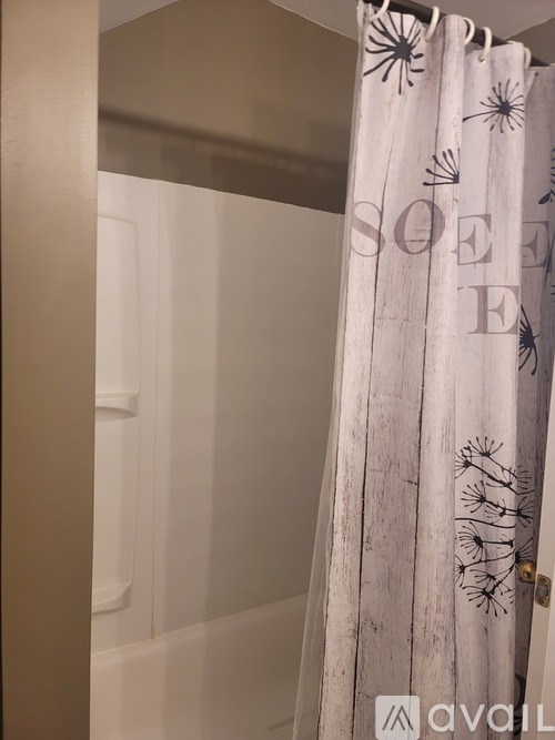 A shower curtain with the word "sea" and some sea creatures on it.