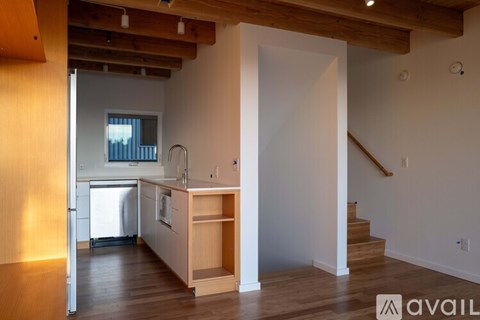 A kitchen with a refrigerator, sink, and cabinets is available for rent.