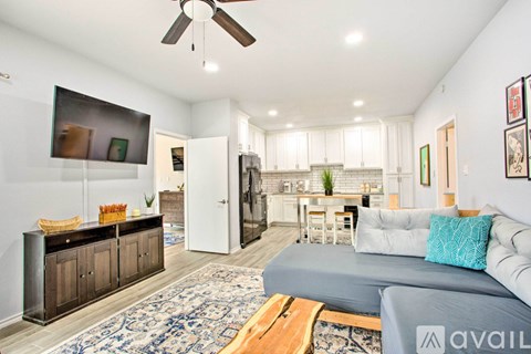 A living room with a grey couch and a wooden coffee table.