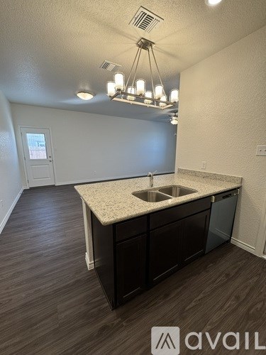 A kitchen with a sink and cabinets.
