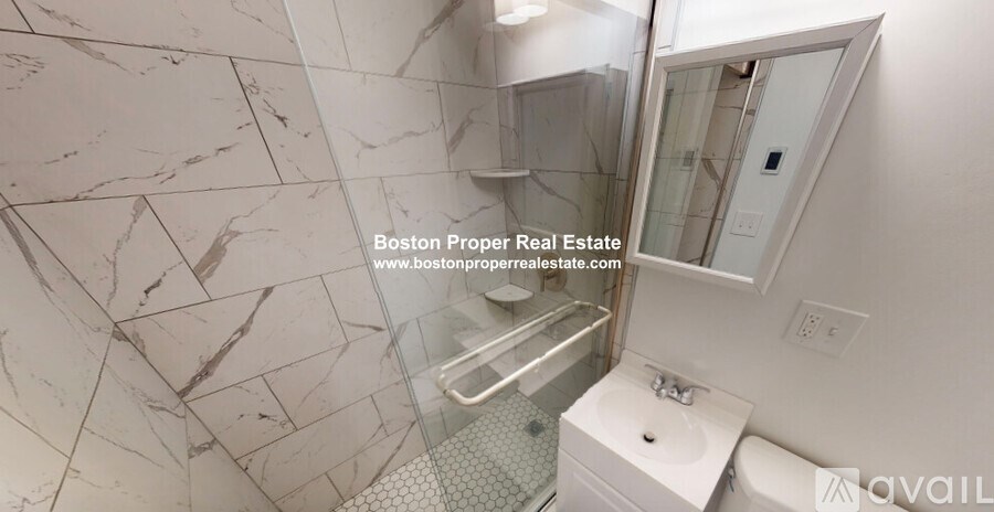 A marble bathroom with a walk-in shower and a toilet.
