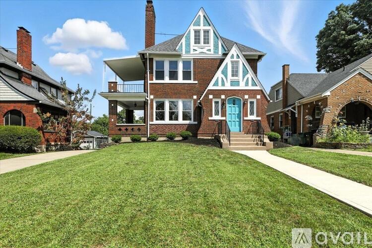 A house with a blue door and white trim is shown.