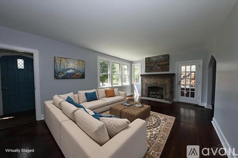 A living room with a couch and a fireplace.