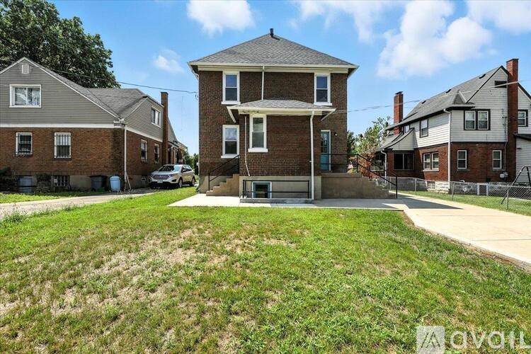 A house with a large front yard is for sale.