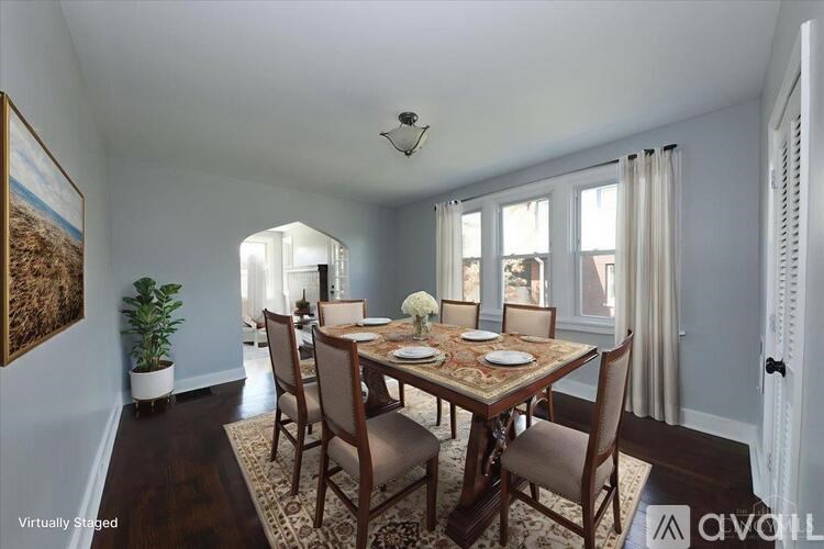 A dining room with a wooden table and chairs.