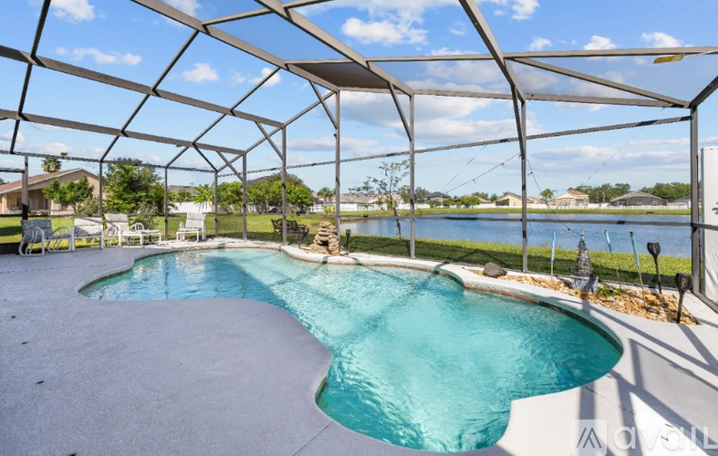 A large outdoor pool under a white canopy.