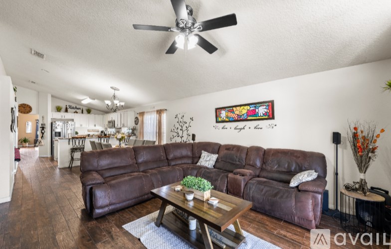 A bedroom with a bed, chair, and window.