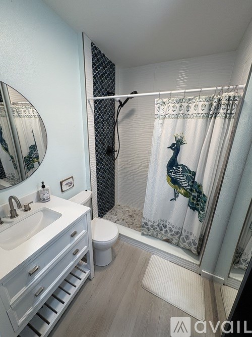 A bathroom with a deer shower curtain.