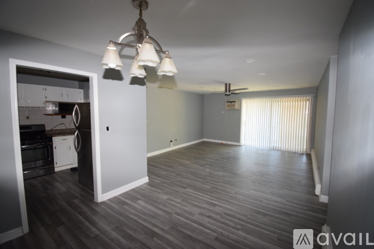 A room with a grey floor and a white door.