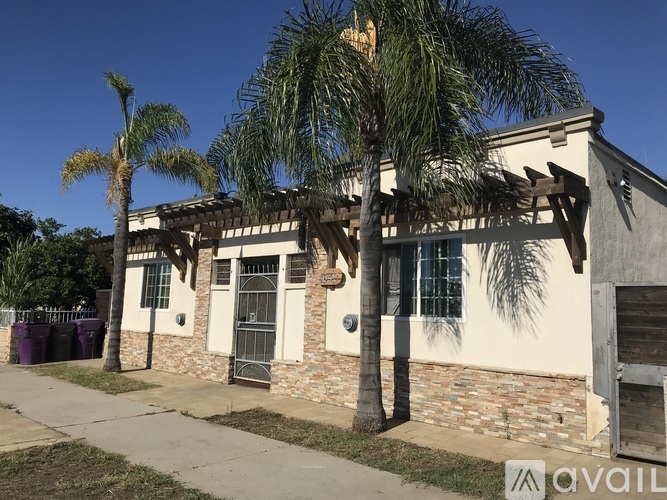 A house with a palm tree in front of it.